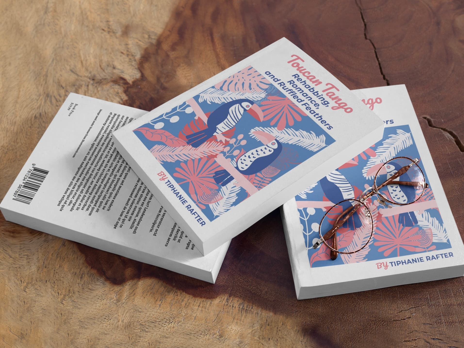 Three copies of the Toucan Tango paperback stacked on a wooden table, showing the front cover, back cover, and spine
