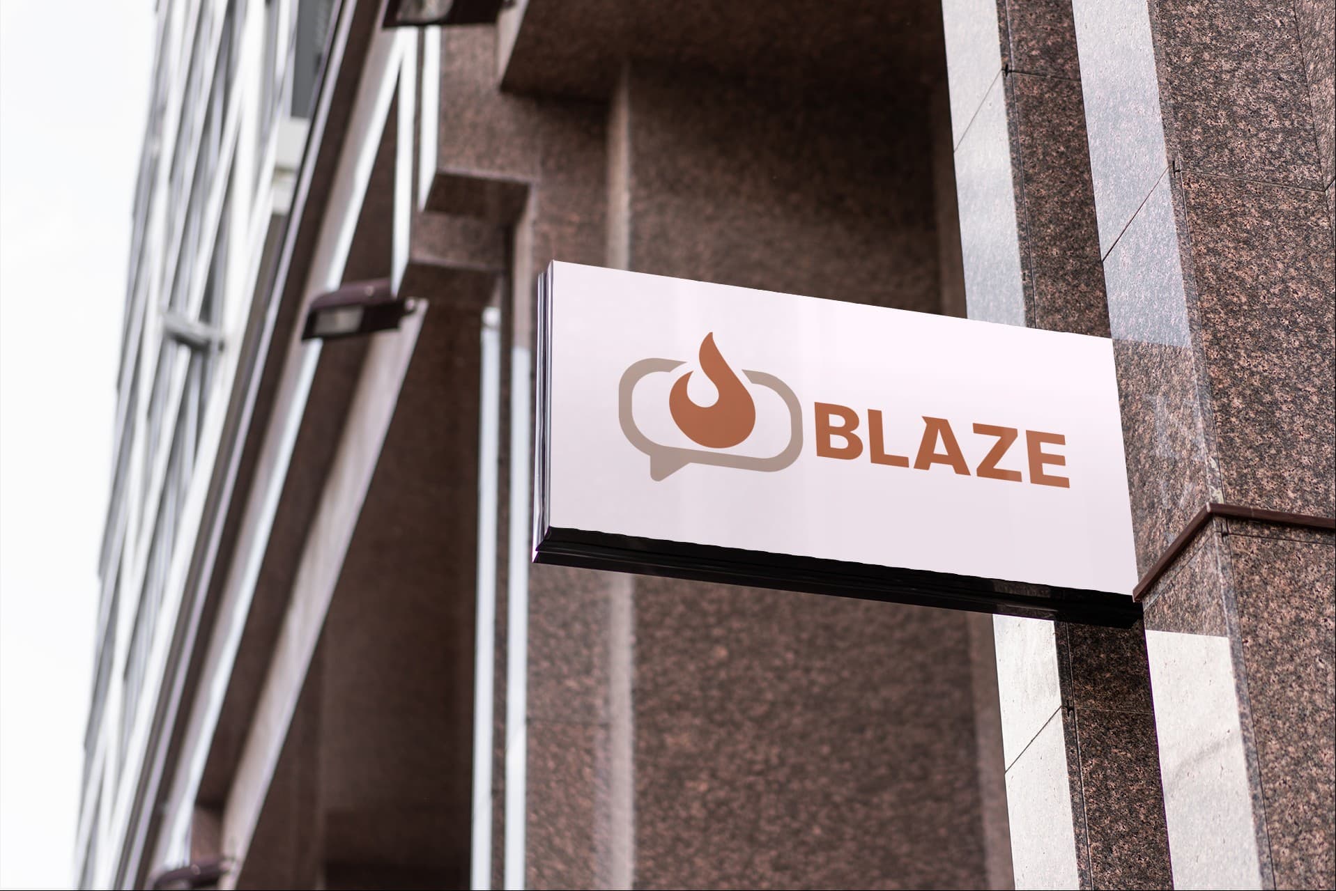 The full BLAZE lockup on exterior signage mounted to a stone building.